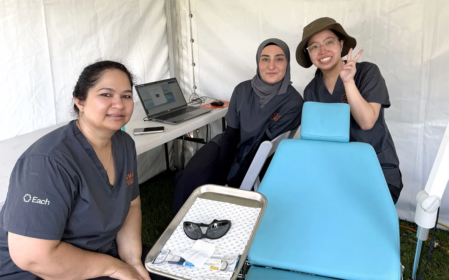 Three women dental professionals with dental chaor
