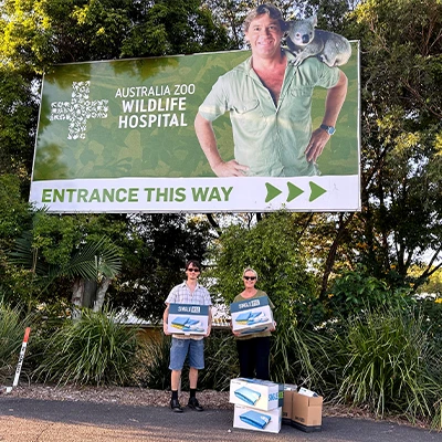 two-people-holding-single-use-medical-supplies-donation-outside-australia-zoo-wildlife-warriors-hospital-thumbnail