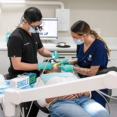 dentist-and-dental-assistant-performing-treatment-in-modern-dental-practice_Thumbnail